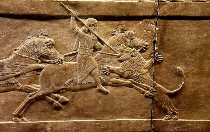 Il re assiro Ashurbanipal sul suo cavallo ha spinto una lancia sulla testa di un leone