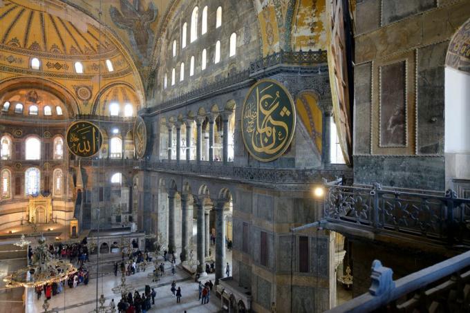 enorme spazio interno alto 180 piedi circondato da finestre ad arco, mosaici e un'enorme cupola con pendenti