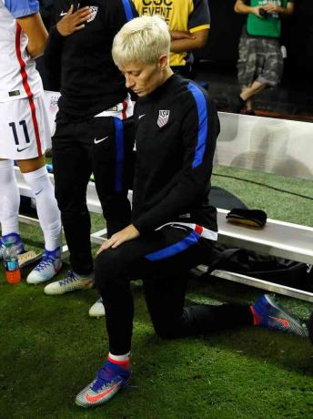 Fotografia della stella del calcio femminile Megan Rapinoe in ginocchio durante l'inno nazionale