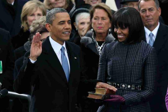 Barack Obama con la mano sulle bibbie giurata accanto a sua moglie per il suo secondo mandato.